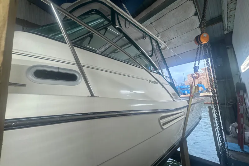 Slide: The Image of 2000 Pursuit 3000 Express boat in a dockside storage facility. - 4