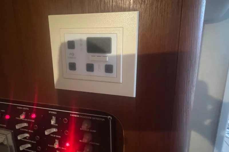 Slide: The Image of Control panel on 2000 Pursuit 3000 Express boat, featuring switches and digital display. - 23