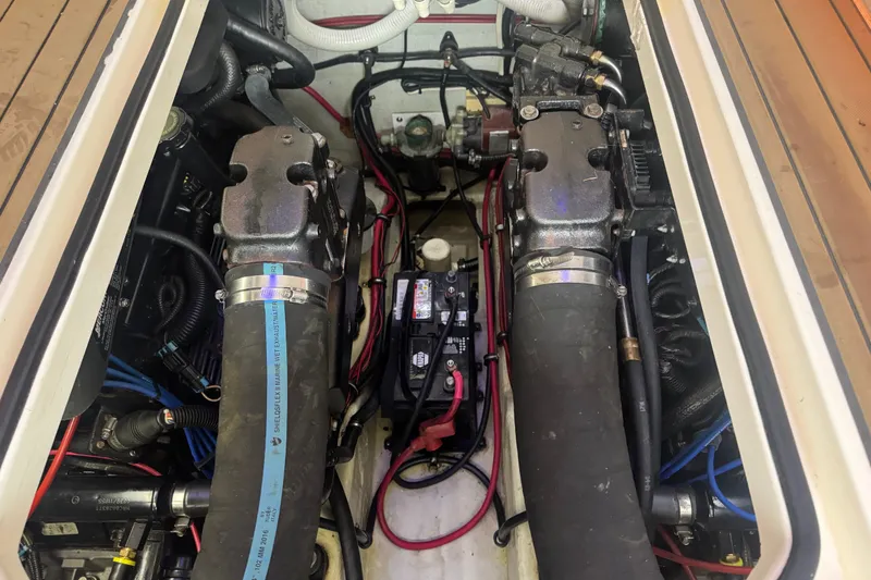 Slide: The Image of Engine compartment of a 2000 Pursuit 3000 Express boat, showing hoses and battery. - 26