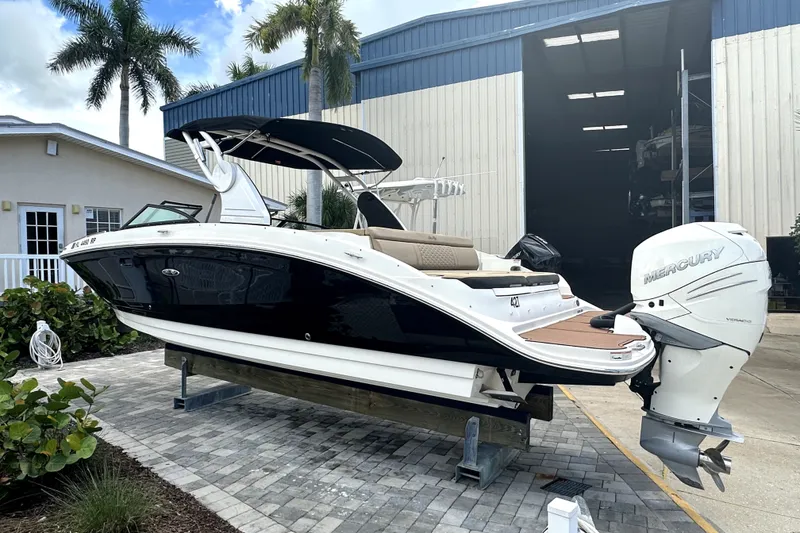 Slide: The Image of 2018 Sea Ray SDX 270 Outboard boat with Mercury engine, docked near a warehouse. - 3