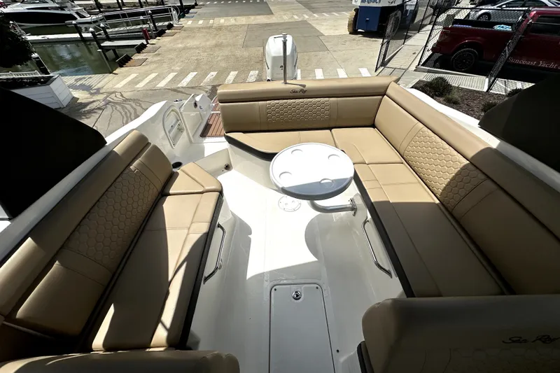 Slide: The Image of Interior view of 2018 Sea Ray SDX 270 Outboard boat with beige seating and table. - 10