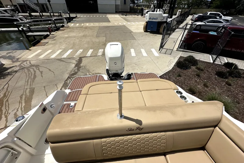 Slide: The Image of 2018 Sea Ray SDX 270 Outboard boat with tan seating at a marina dock. - 12