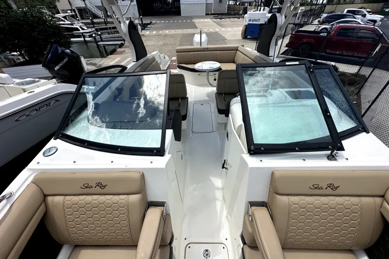 Slide: The Image of 2018 Sea Ray SDX 270 Outboard boat interior with beige seating and windshield. - 8