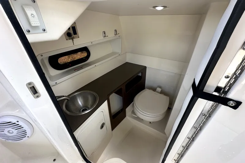 Slide: The Image of Interior of 2018 Sea Ray SDX 270 Outboard boat bathroom with sink and toilet. - 15