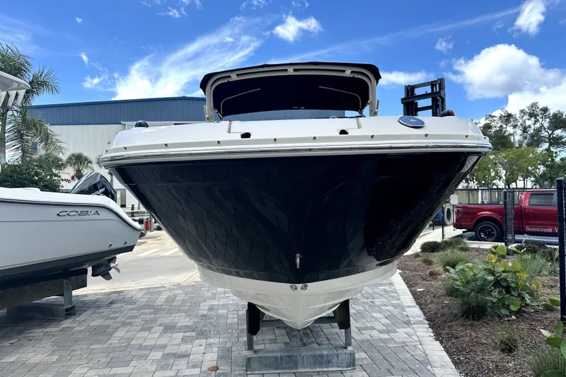 Slide: The Image of 2018 Sea Ray SDX 270 Outboard boat on display, front view under blue sky. - 4