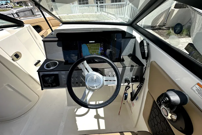 Slide: The Image of 2018 Sea Ray SDX 270 Outboard helm with steering wheel and navigation display. - 14