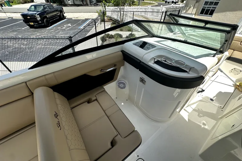 Slide: The Image of Interior view of a 2018 Sea Ray SDX 270 Outboard boat with beige seating and dashboard. - 13