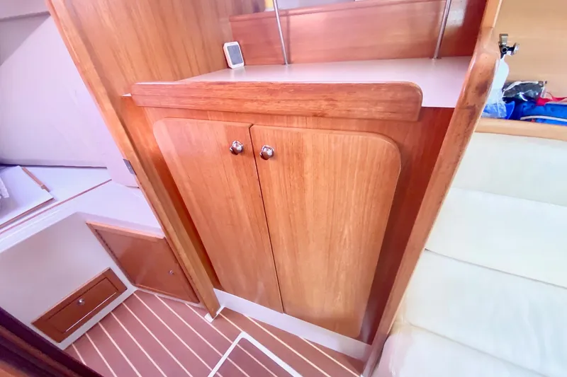 Slide: The Image of Interior of 2007 Catalina 309 sailboat with wooden cabinetry and striped flooring. - 24