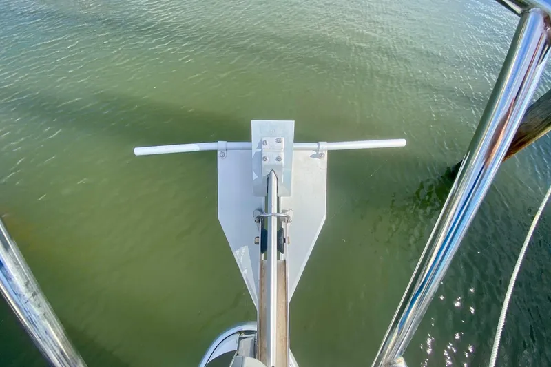 Slide: The Image of Bow view of a 2007 Catalina 309 sailboat with anchor over water. - 44