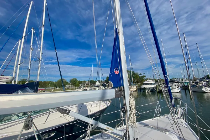 Slide: The Image of Sailboats docked at a marina, featuring a 2007 Catalina 309 under a clear blue sky. - 46