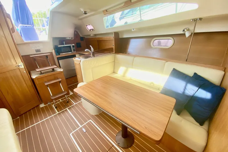Slide: The Image of Interior of 2007 Catalina 309 sailboat with cozy seating and wooden finishes. - 26
