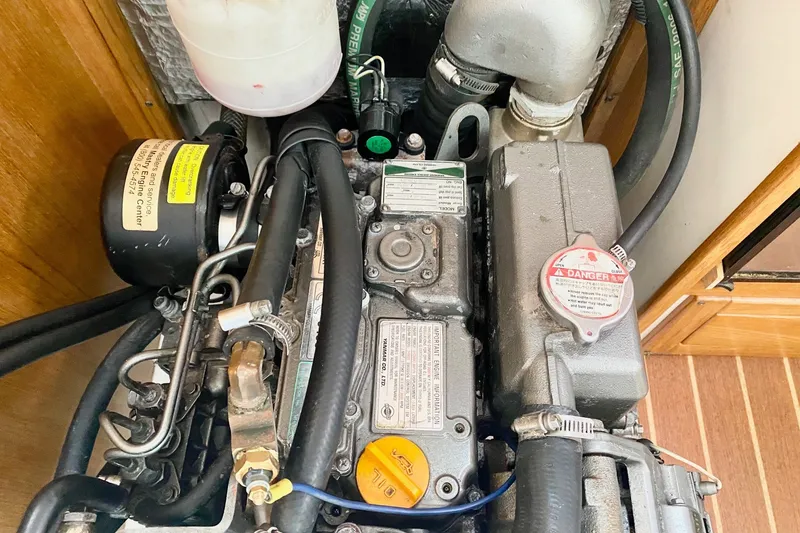 Slide: The Image of Engine compartment of a 2007 Catalina 309 sailboat, showcasing detailed mechanical components. - 38