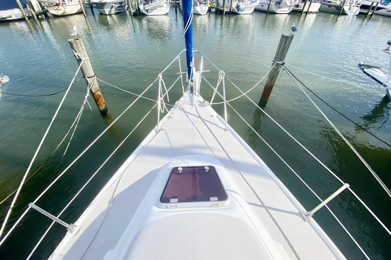 Slide: The Image of Bow view of a 2007 Catalina 309 sailboat docked in a marina. - 42
