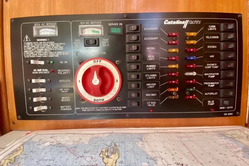 Slide: The Image of Electrical control panel of a 2007 Catalina 309 yacht with various switches and fuses. - 40