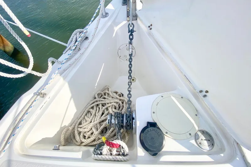 Slide: The Image of Anchor locker of 2007 Catalina 309 sailboat with ropes and chain. - 43