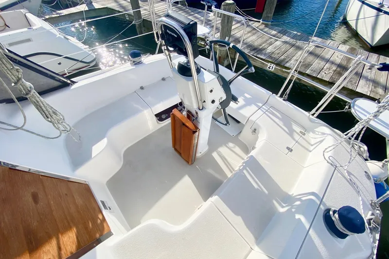 Slide: The Image of Cockpit of a 2007 Catalina 309 sailboat, featuring steering wheel and seating. - 51
