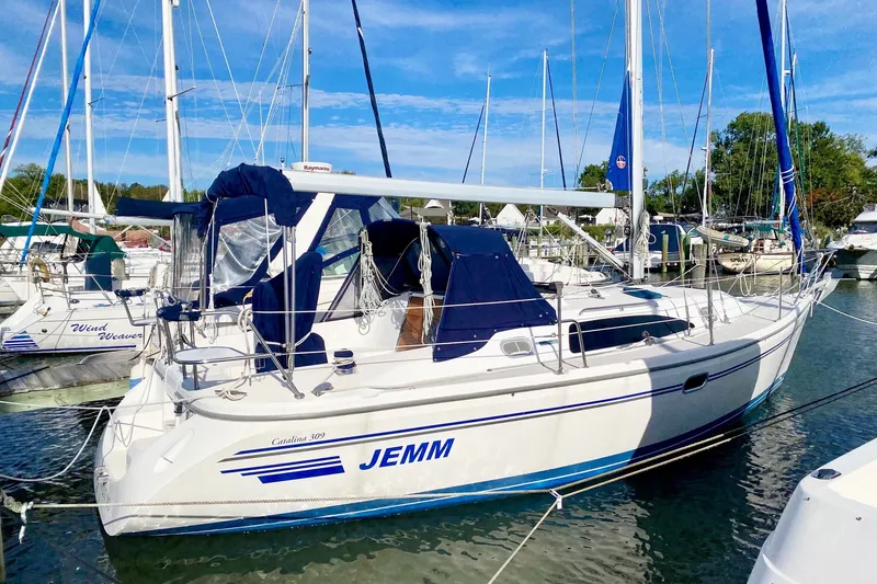 Slide: The Image of 2007 Catalina 309 sailboat docked in marina under clear blue sky. - 61