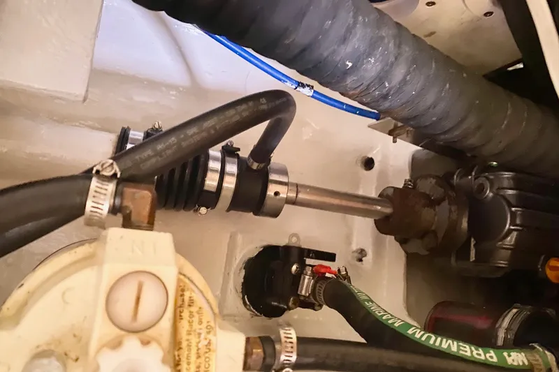 Slide: The Image of Engine compartment of a 2007 Catalina 309 sailboat, showing hoses and mechanical components. - 39