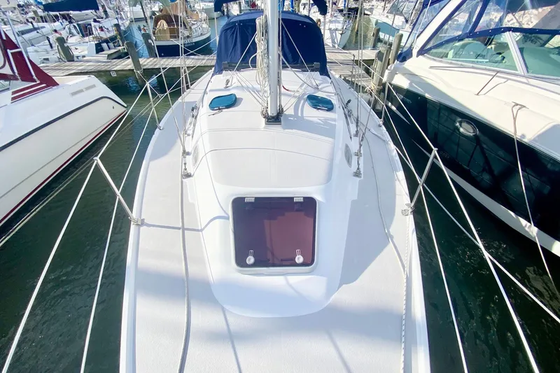 Slide: The Image of Catalina 309 sailboat from 2007 docked at a marina, viewed from above. - 48