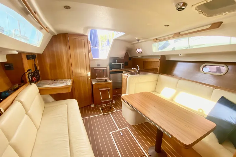 Slide: The Image of Luxurious interior of a 2007 Catalina 309 sailboat with wood finishes and comfortable seating. - 15