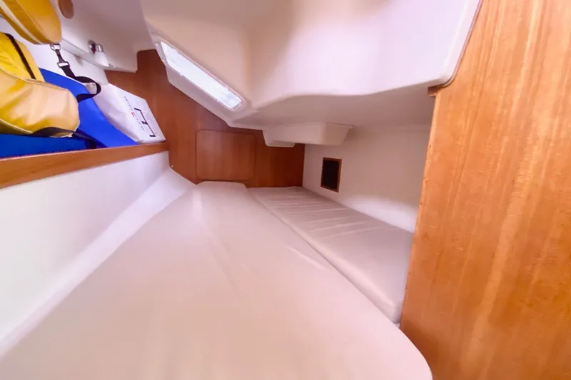 Slide: The Image of Interior cabin of a 2007 Catalina 309 sailboat, featuring a cozy sleeping area. - 33