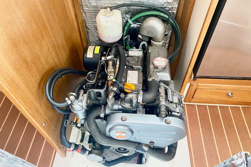 Slide: The Image of Engine compartment of a 2007 Catalina 309 sailboat, showcasing detailed mechanical components. - 37