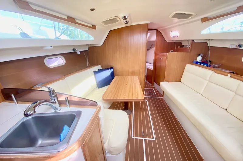Slide: The Image of Interior of 2007 Catalina 309 sailboat with cozy seating and wooden finishes. - 18