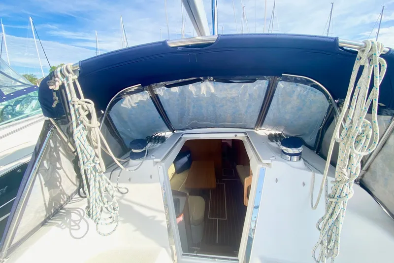 Slide: The Image of 2007 Catalina 309 sailboat cockpit with ropes and covered seating area. - 52