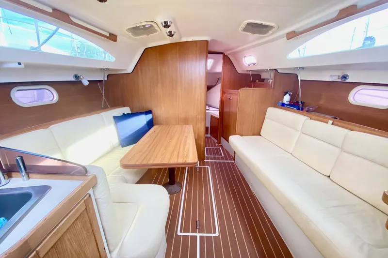Slide: The Image of Interior of 2007 Catalina 309 sailboat with wood finish and cream seating. - 16