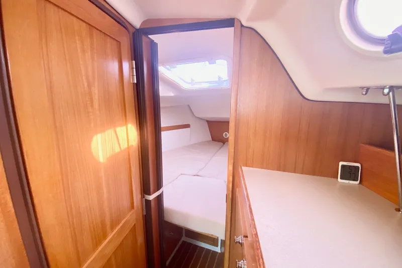 Slide: The Image of Cozy cabin interior of 2007 Catalina 309 sailboat with wooden finish and bed. - 19