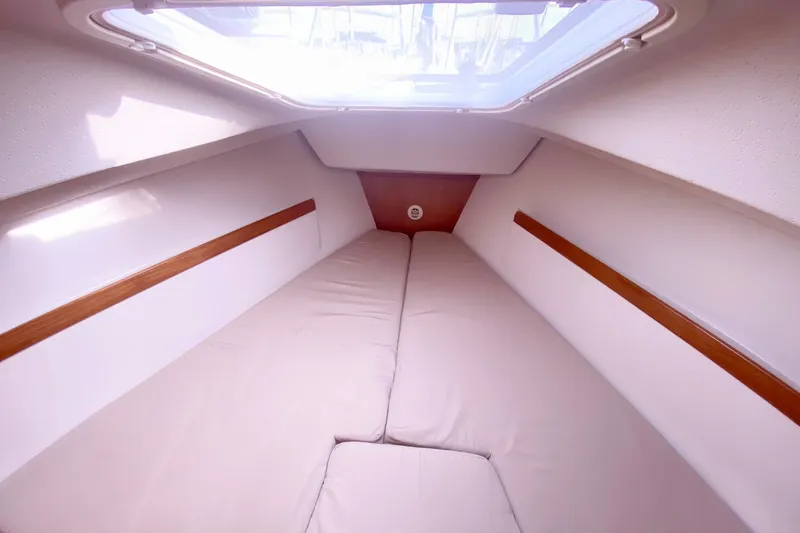 Slide: The Image of Interior cabin of a 2007 Catalina 309 sailboat with cozy bedding and wooden accents. - 20