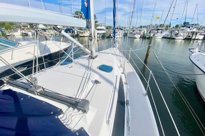 Slide: The Image of 2007 Catalina 309 sailboat docked in a marina, surrounded by other boats. - 41