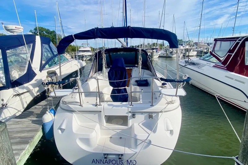 Slide: The Image of 2007 Catalina 309 sailboat docked in Annapolis marina, surrounded by other boats. - 62