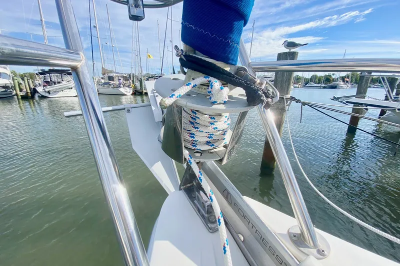 Slide: The Image of Bow of a 2007 Catalina 309 sailboat with anchor and ropes in a marina. - 45