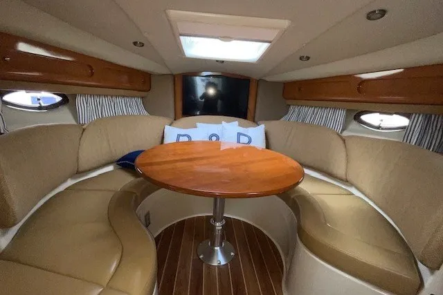 Slide: The Image of 2007 Chaparral Signature 330 cabin interior with cozy seating and wooden table. - 11
