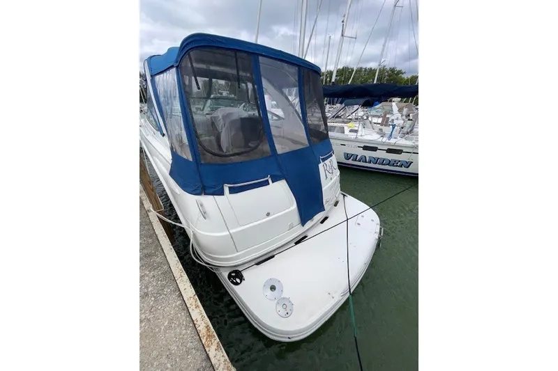 Slide: The Image of 2007 Chaparral Signature 330 boat docked with blue canopy in marina. - 3