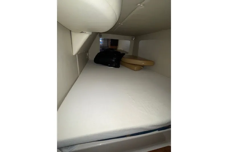 Slide: The Image of 2007 Chaparral Signature 330 cabin interior with bed and storage space. - 12