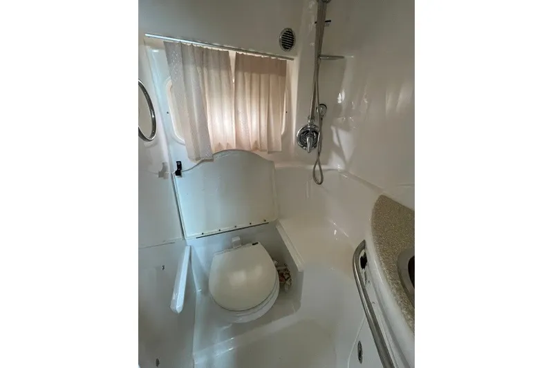 Slide: The Image of 2007 Chaparral Signature 330 bathroom with shower, toilet, and sink. - 14