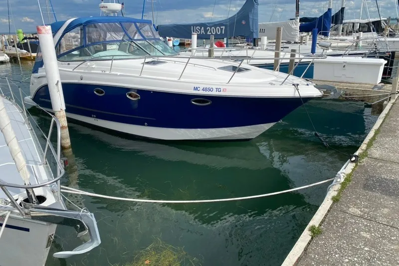 The Image of 2007 Chaparral Signature 330 boat docked at a marina, featuring a sleek blue and white design. - 0