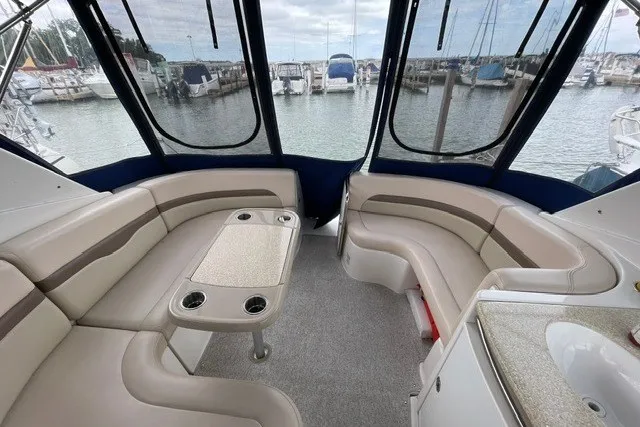 Slide: The Image of 2007 Chaparral Signature 330 boat interior with spacious seating and marina view. - 6