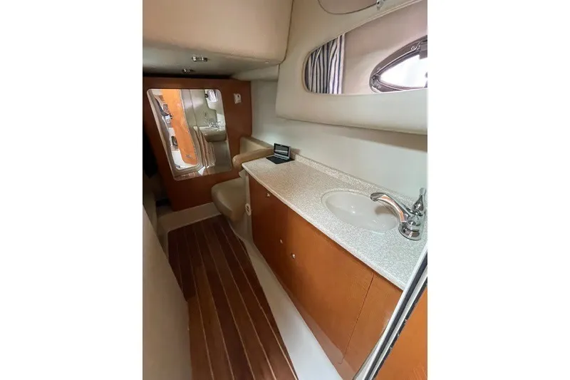 Slide: The Image of 2007 Chaparral Signature 330 yacht bathroom with wooden cabinetry and modern fixtures. - 13