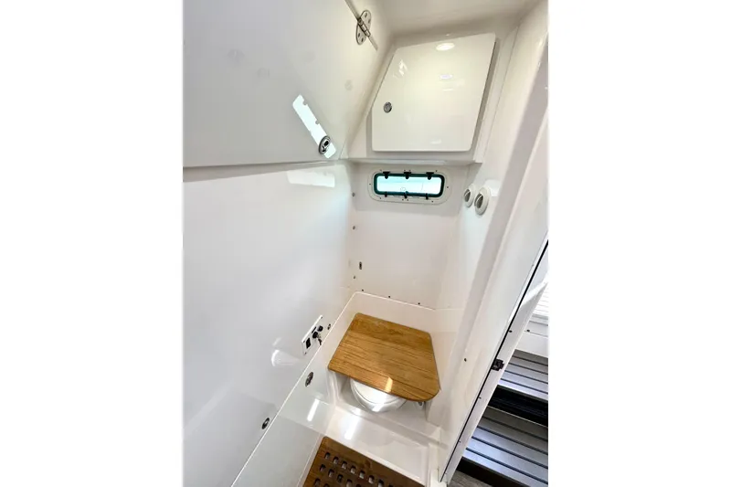 Slide: The Image of 2023 Everglades 395 Center Console interior with wooden seat and compact design. - 48
