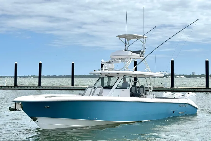 The Image of 2023 Everglades 395 Center Console boat docked on calm water. - 0
