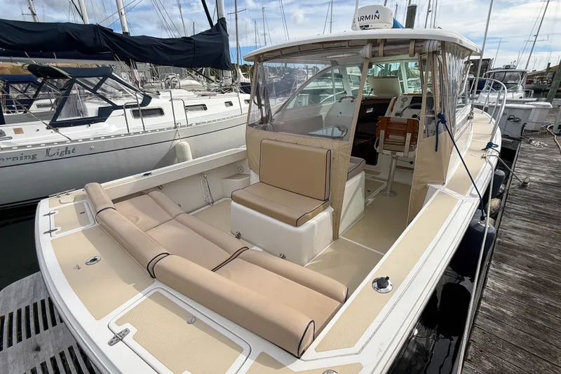 Slide: The Image of 2004 Hunt Yachts Surfhunter 29 docked, featuring spacious seating and helm area. - 3