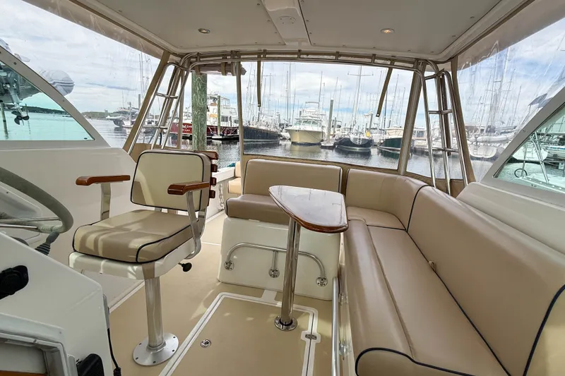 Slide: The Image of 2004 Hunt Yachts Surfhunter 29 interior with seating and table, docked at marina. - 27