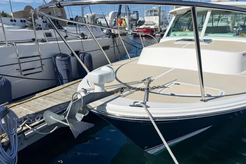 Slide: The Image of 2004 Hunt Yachts Surfhunter 29 docked, showcasing anchor and deck details. - 28
