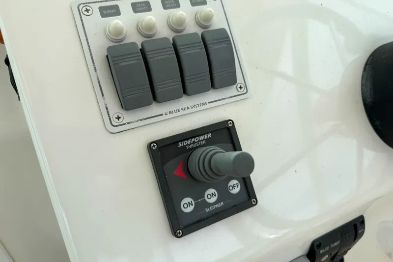 Slide: The Image of Control panel of a 2004 Hunt Yachts Surfhunter 29 with switches and thruster joystick. - 13