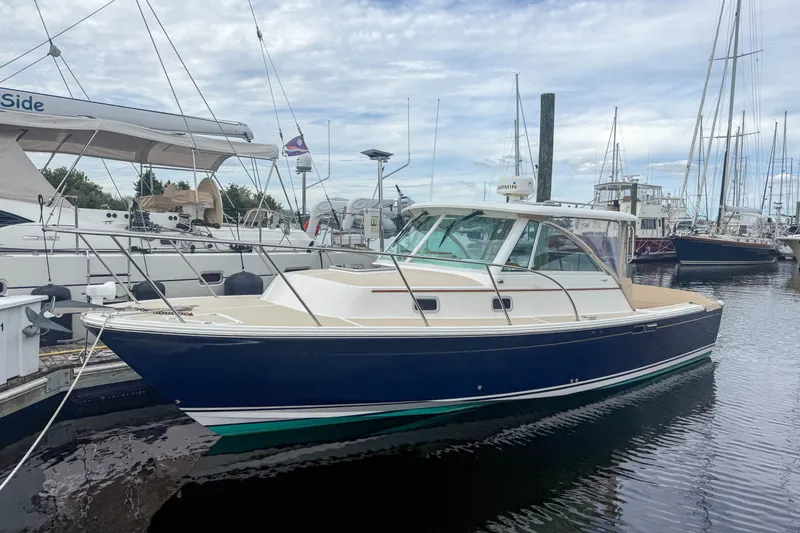 Slide: The Image of 2004 Hunt Yachts Surfhunter 29 docked at a marina, showcasing sleek design and craftsmanship. - 1