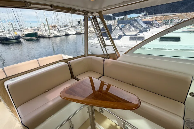 Slide: The Image of Interior of 2004 Hunt Yachts Surfhunter 29 with elegant seating and wooden table. - 6