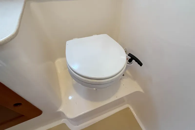 Slide: The Image of 2004 Hunt Yachts Surfhunter 29 marine toilet in compact bathroom setting. - 26